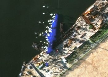 North Korea arrests four over failed warship launch as images show vessel shielded from prying eyes